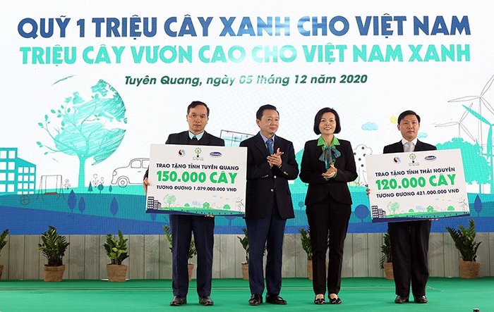 Bộ trưởng Bộ Tài nguyên và Môi trường Trần Hồng Hà và Giám đốc Điều hành Hành chính - Nhân sự - Đối ngoại, Công ty Vinamilk Bùi Thị Hương trao biểu trưng tặng cây cho hai tỉnh Tuyên Quang và Thái Nguyên